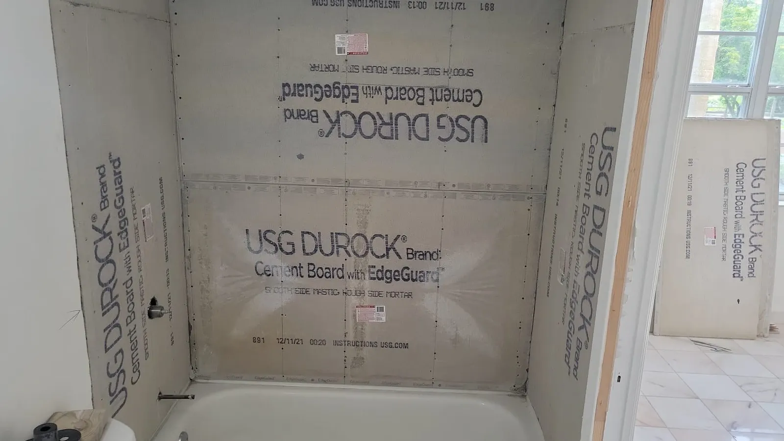 Bathtub alcove lined with USG Durock cement board ready for tile.